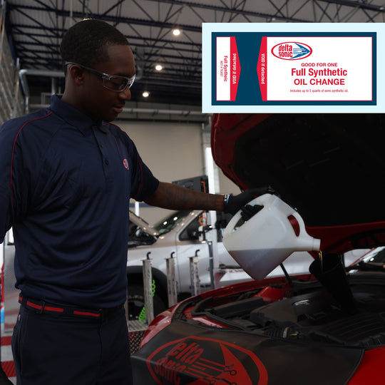 Delta Sonic employee pouring full synthetic oil into car.