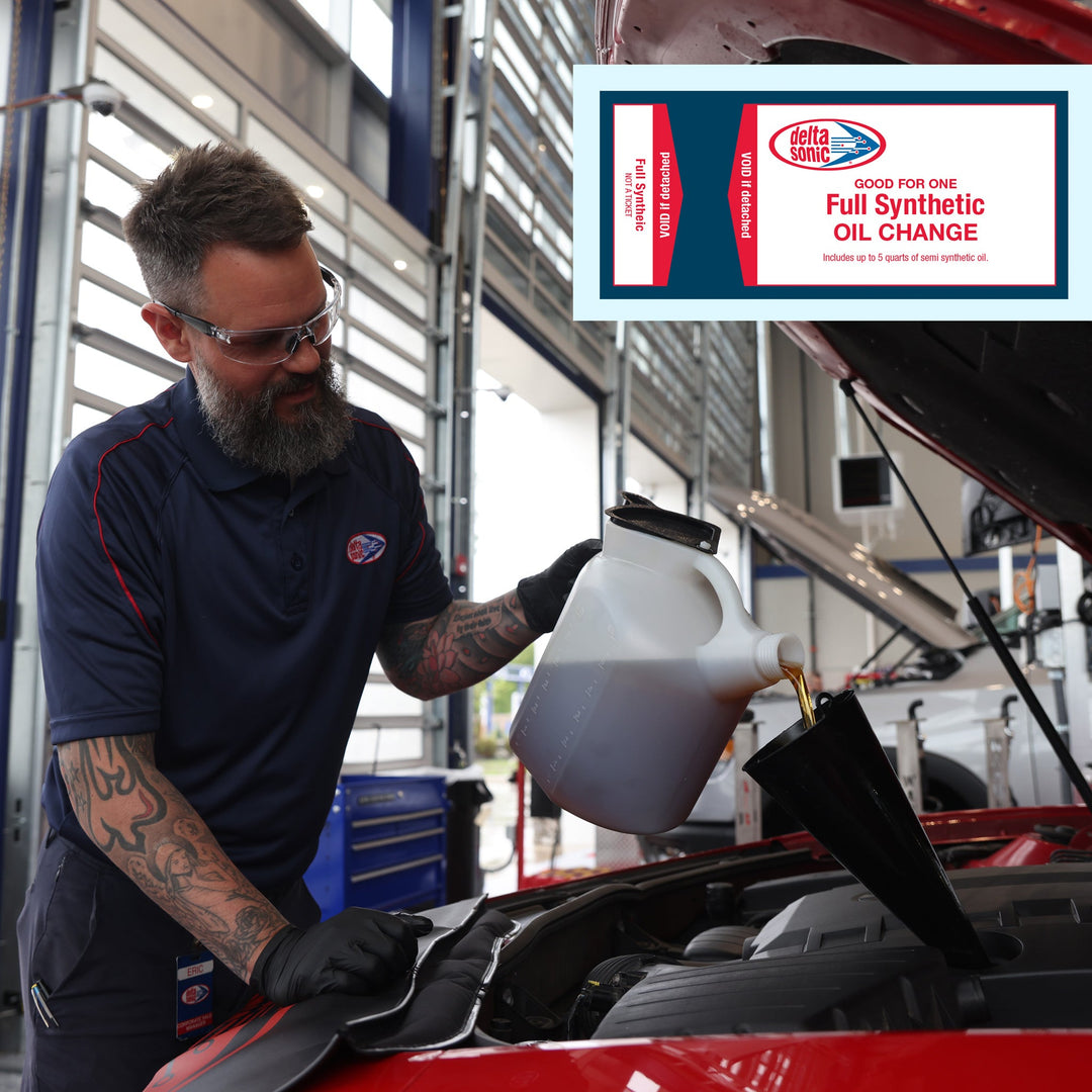 Delta Sonic employee performing full synthetic oil change